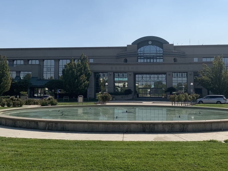 Picure of large building with fountain and grass in front