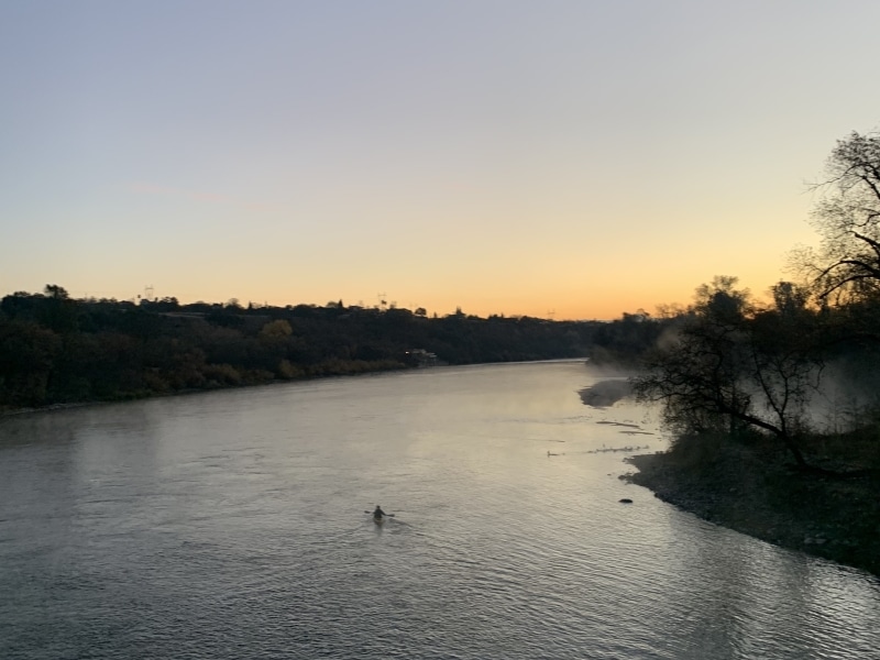 the sacramento river at sunset, with a kayak in distance