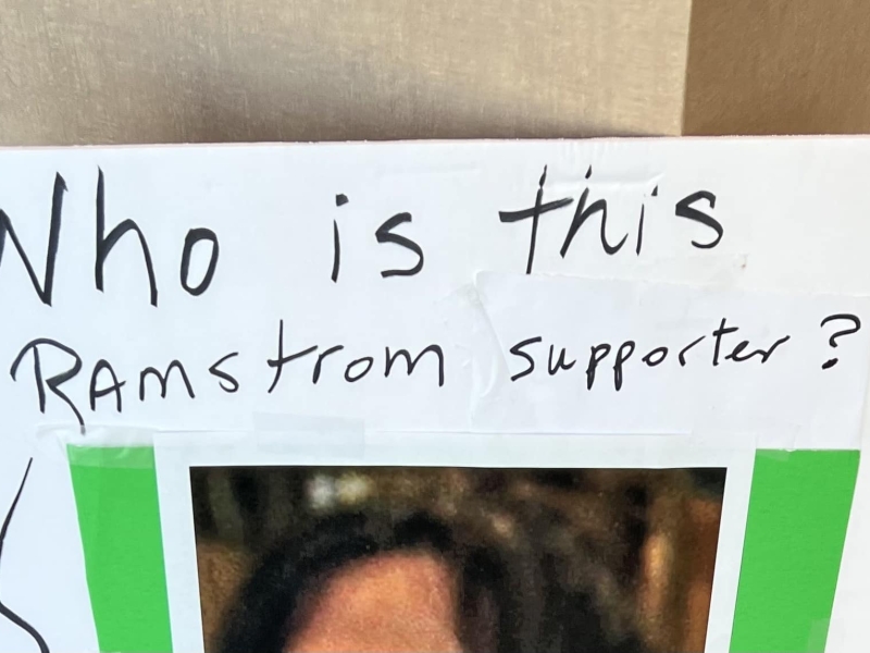 Handmade poster reads "who is this Ramstrom supporter?"